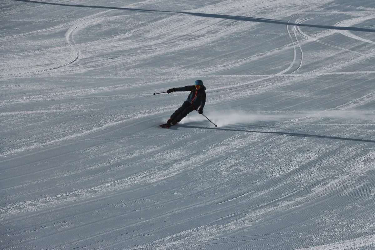A skier carving a turn on a snowy slope. This photograph illustrates the activity, not a specific Colorado location.