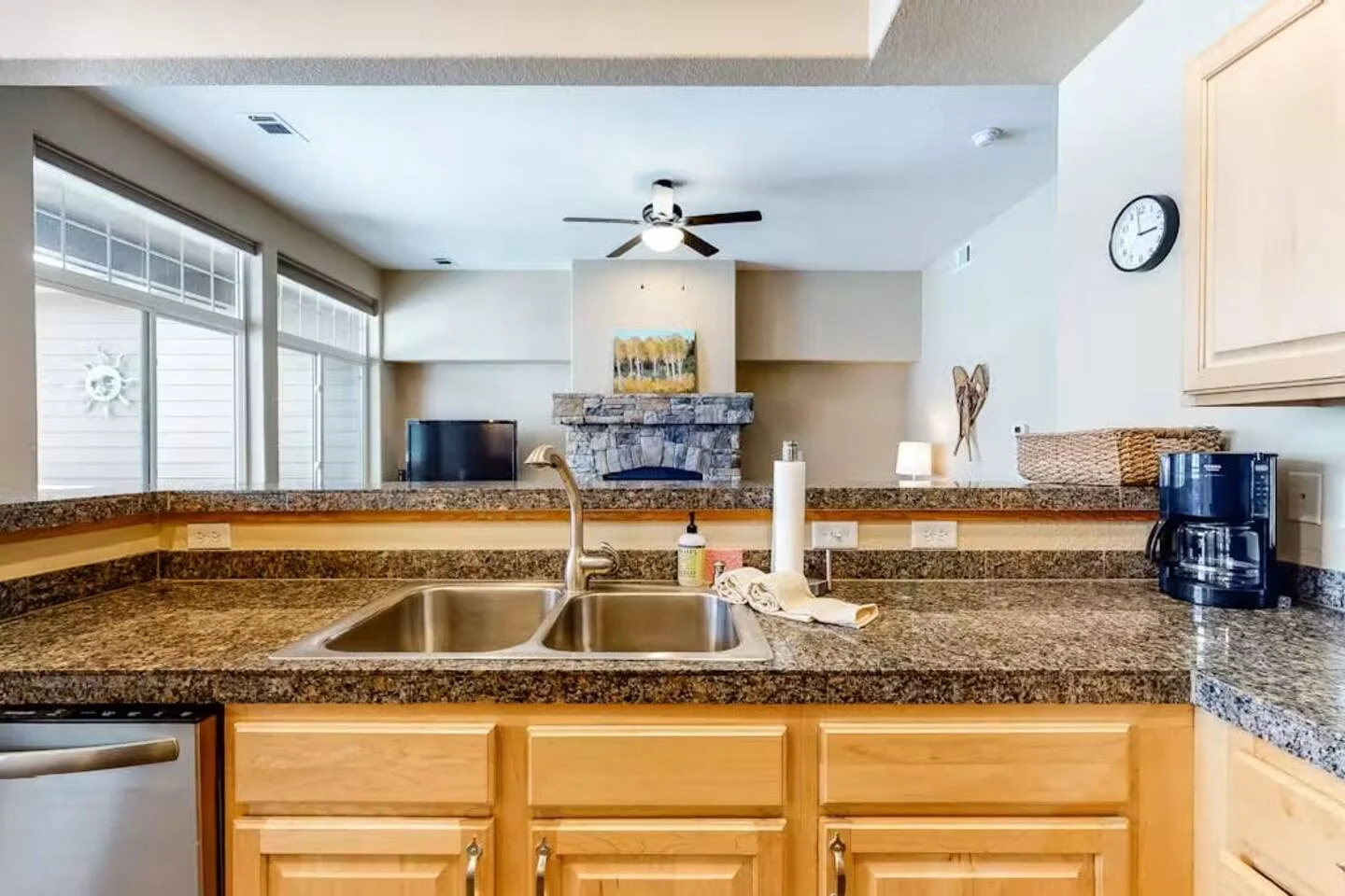 North Pond Retreat, Kitchen sink and stone countertops overlooking the fireplace in the living room, waterfront vacation rental in Silverthorne, Colorado