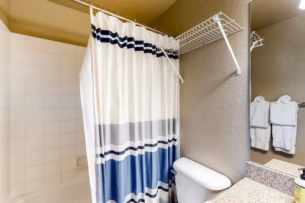 North Pond Retreat, Bathroom with a bathtub, shower curtain, vanity, and toilet, waterfront vacation rental in Silverthorne, Colorado