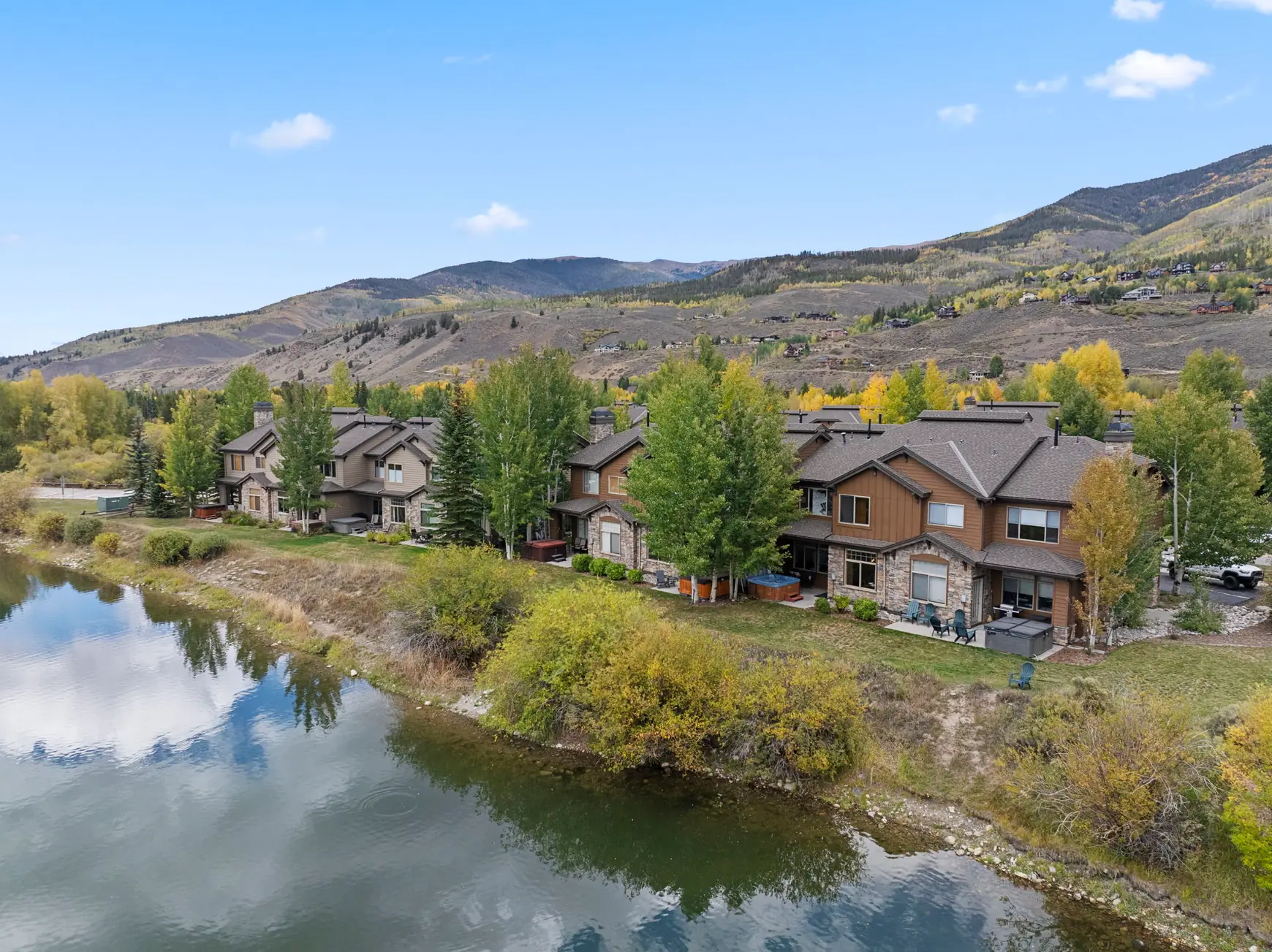 North Pond Retreat, Elevated view of waterfront homes and trees along the edge of the pond, waterfront vacation rental in Silverthorne, Colorado