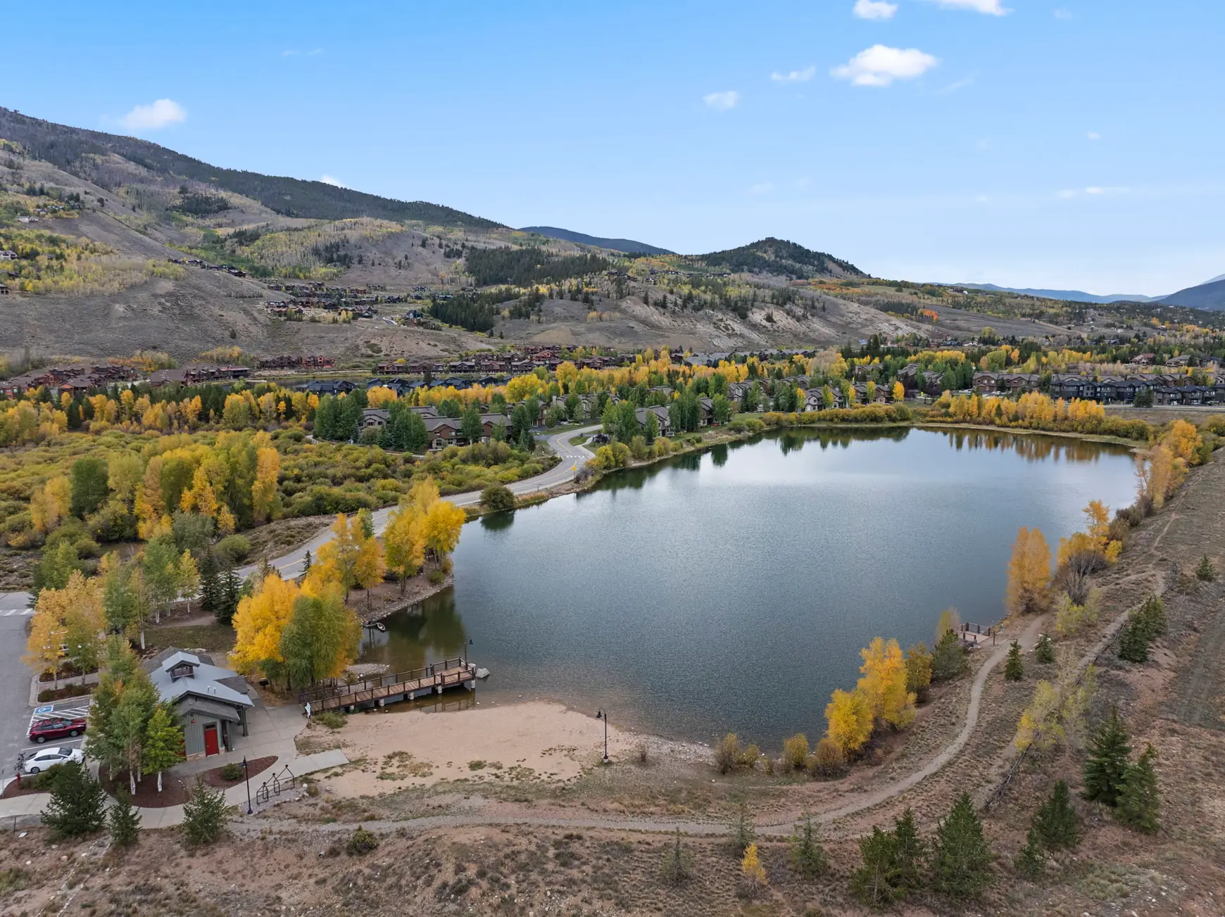 North Pond Retreat, Aerial view of North Pond, its surrounding paths and trees, and the mountain landscape, waterfront vacation rental in Silverthorne, Colorado