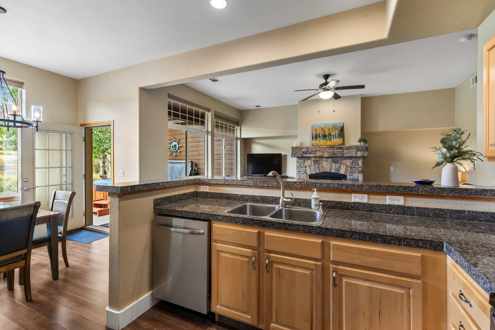 North Pond Retreat, Kitchen sink and countertops overlooking the sofas and stone fireplace, waterfront vacation rental in Silverthorne, Colorado