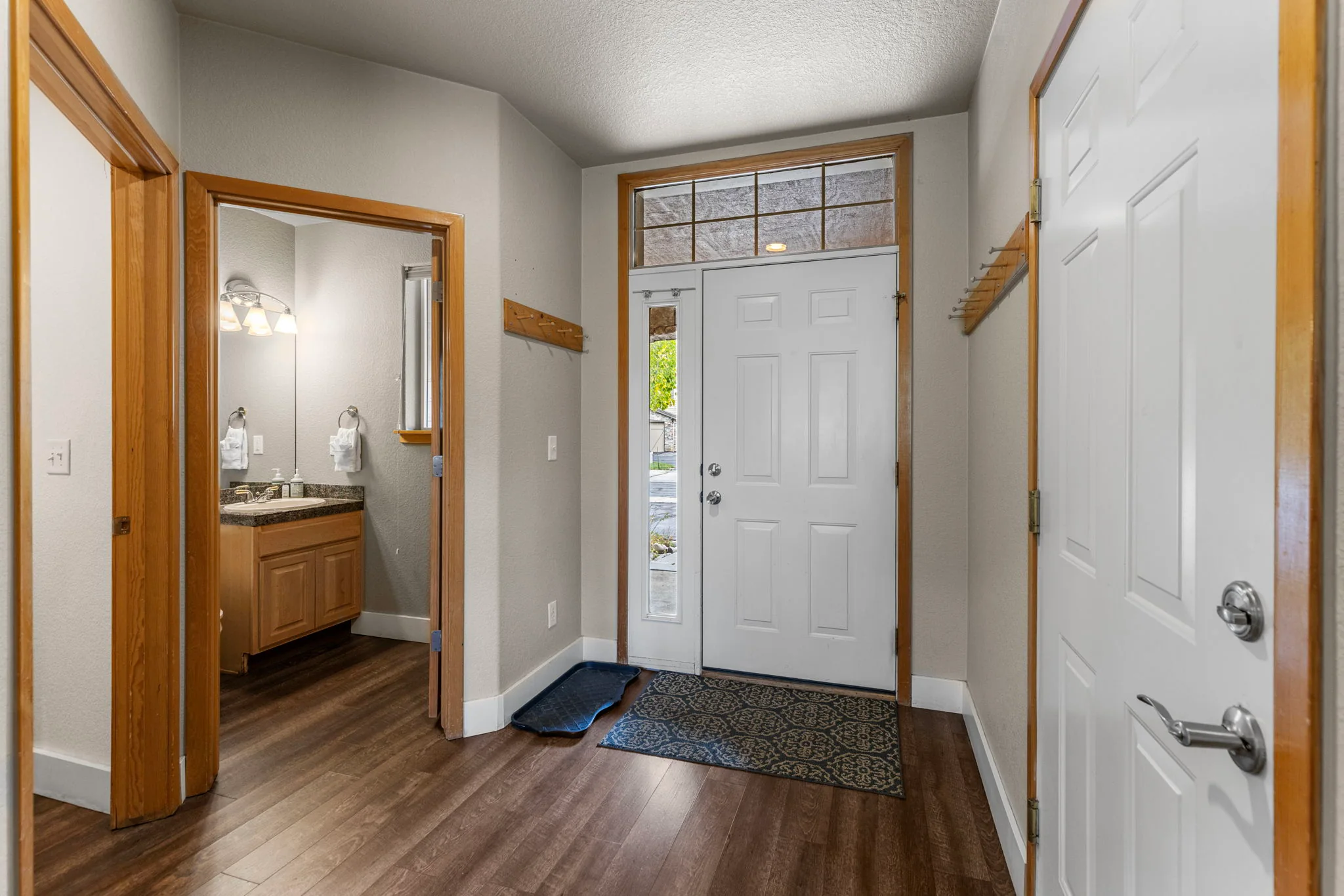 North Pond Retreat, Front entry with a white door, wood trim, storage space, and an adjacent powder room, waterfront vacation rental in Silverthorne, Colorado