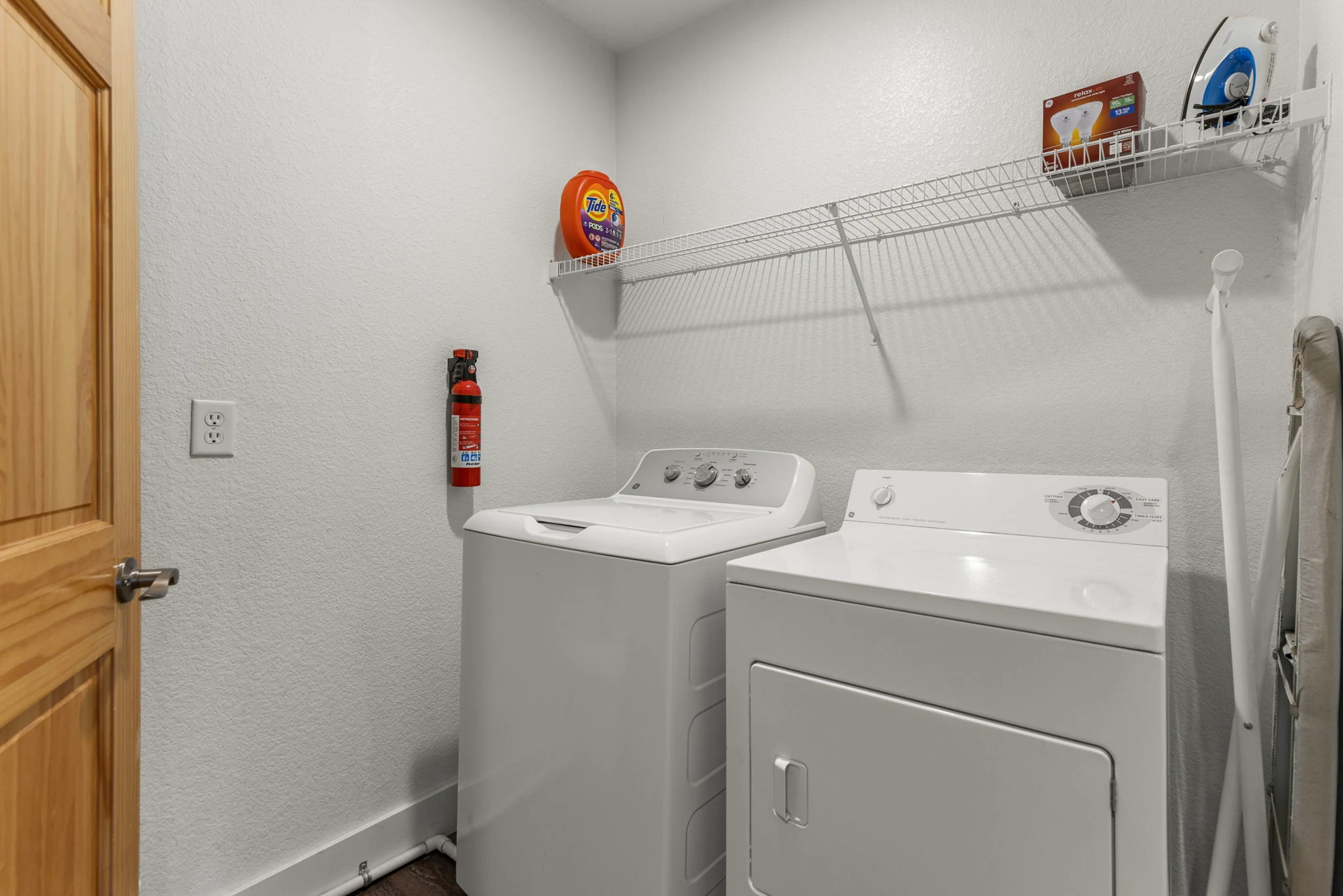North Pond Retreat, Washer and dryer beneath storage shelves in the home's laundry area, waterfront vacation rental in Silverthorne, Colorado