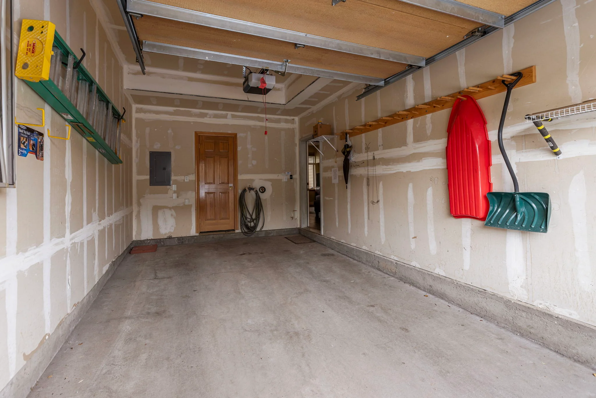 North Pond Retreat, Garage with an empty parking area, skis, storage racks, and tools along the walls, waterfront vacation rental in Silverthorne, Colorado