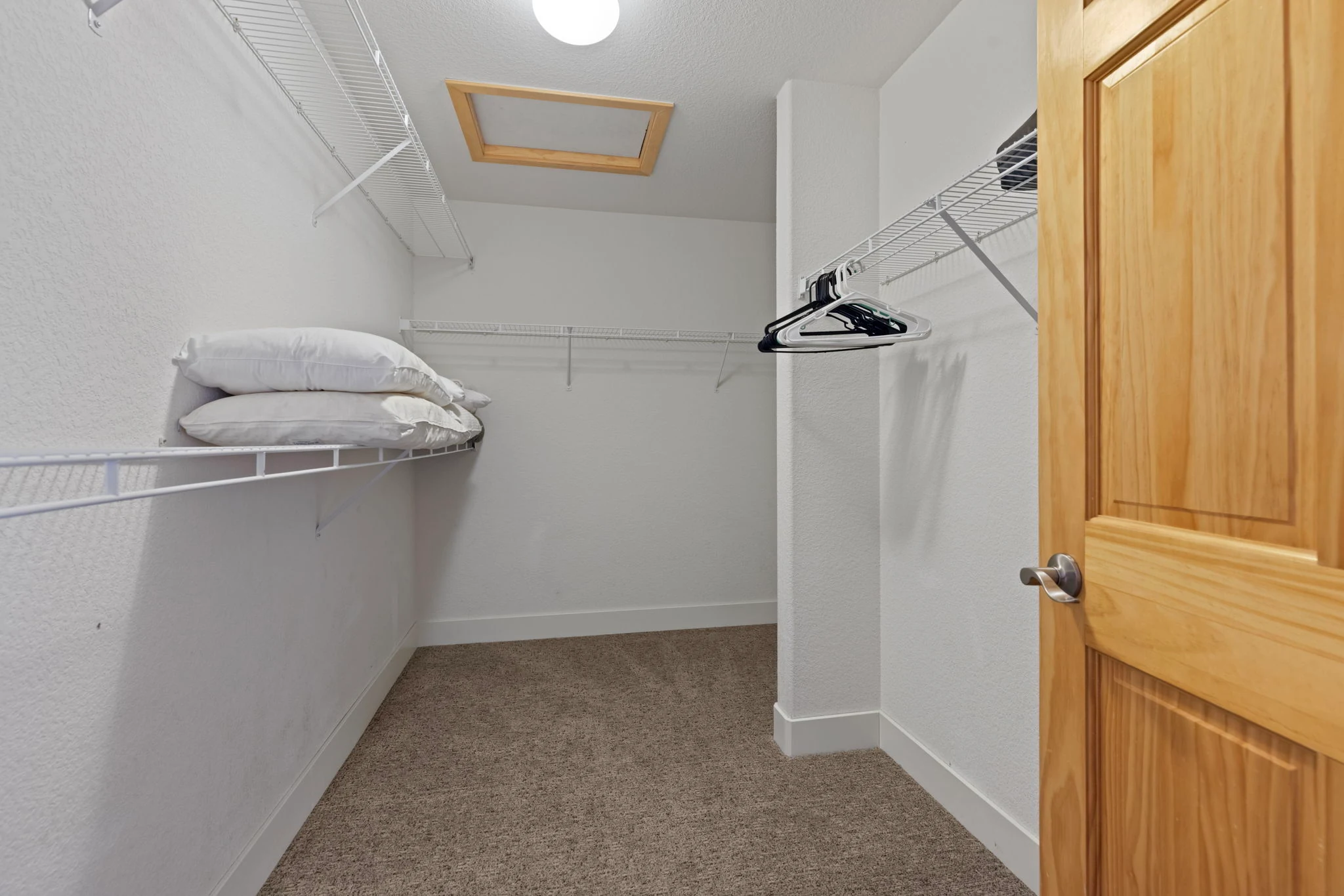 North Pond Retreat, Closet with wraparound shelves, hanging rails, hangers, and spare bedding, waterfront vacation rental in Silverthorne, Colorado