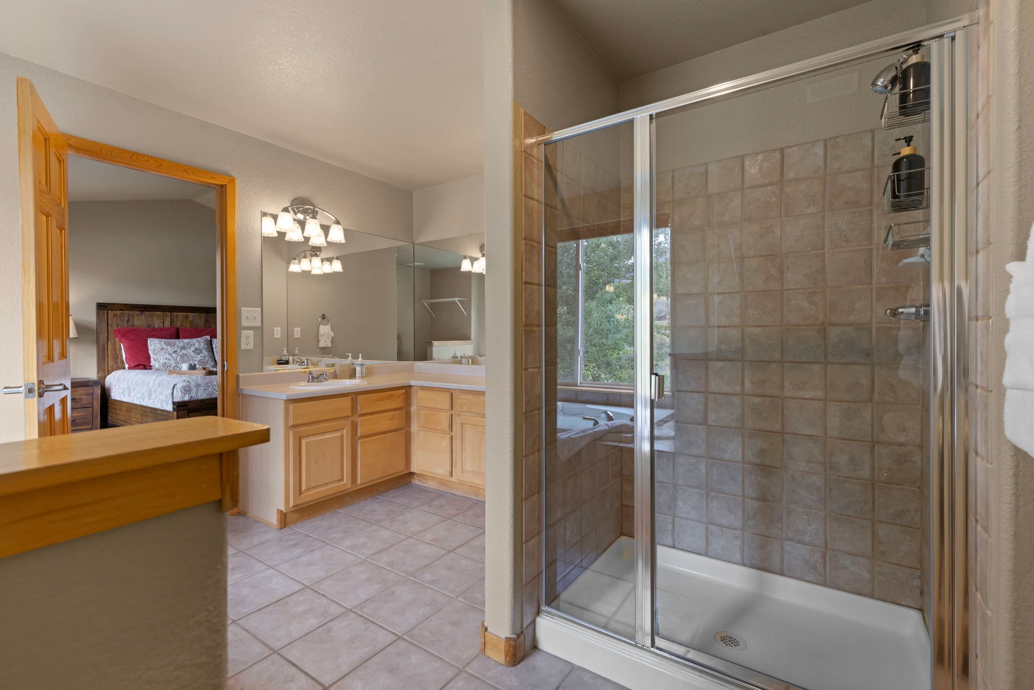 North Pond Retreat, Glass shower enclosure beside the bathroom's double vanity and bedroom doorway, waterfront vacation rental in Silverthorne, Colorado