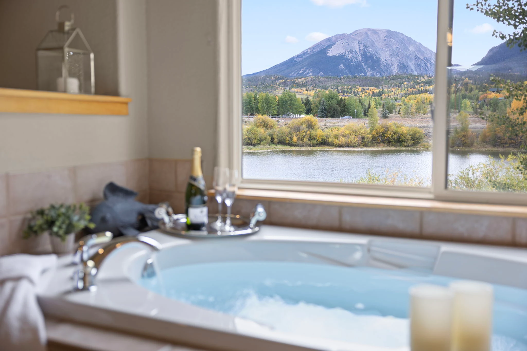 North Pond Retreat, Bathtub with candles and refreshments beside a window framing the mountains, waterfront vacation rental in Silverthorne, Colorado